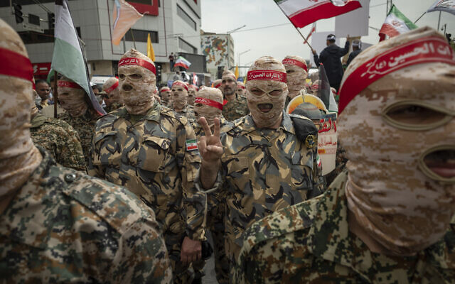 An Islamic Revolutionary Guard Corps soldier flashes a Victory sign during Tehran's 'Jerusalem Day' rally May 2022 (Photo: Morteza Nikoubazl/NurPhoto)