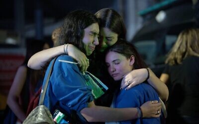 People cry and hug during a demonstration in support of Israel