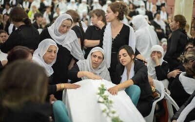 Women mourn during the funeral of their relatives at the Druze town of Majdal Shams. Twelve children and young people were killed when a rocket fired by the Iran-backed Hezbollah militia in southern Lebanon hit a football field in the Israeli-occupied Golan Heights. Credit: Ilia Yefimovich/dpa/Alamy Live News