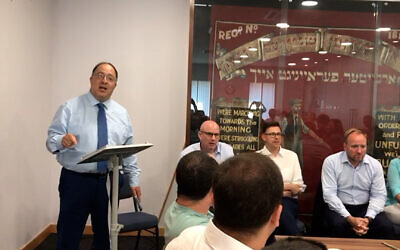 Rabbi David Mason speaking alongside the 1936 Hebrew Yiddish union banner in the GMB's offices (Photo: Jewish News)