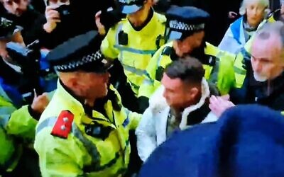 Tommy Robinson is led away from the rally on Sunday.