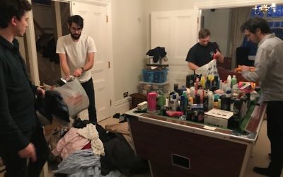 Four sibling volunteers of the Linkey Initiative, (L-R) Jonny Langleben, Joel Bowman, Josh Adley and Adam Langleben, sorting goods for the homeless