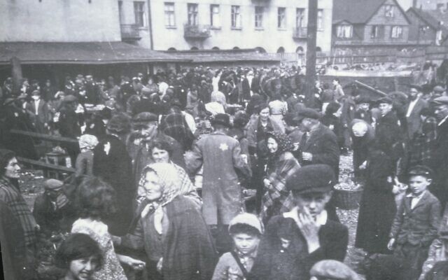 Lodz Ghetto memorial photograph, showing Zigi Shipper, foreground, touching his hand to his face. Pic: Darren Richman