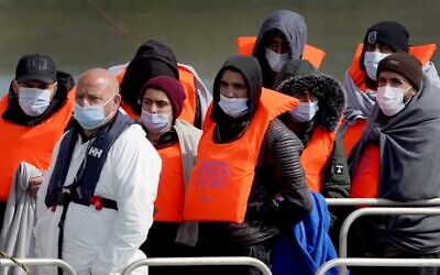 A group of people thought to be migrants are brought in to Dover. (PA)